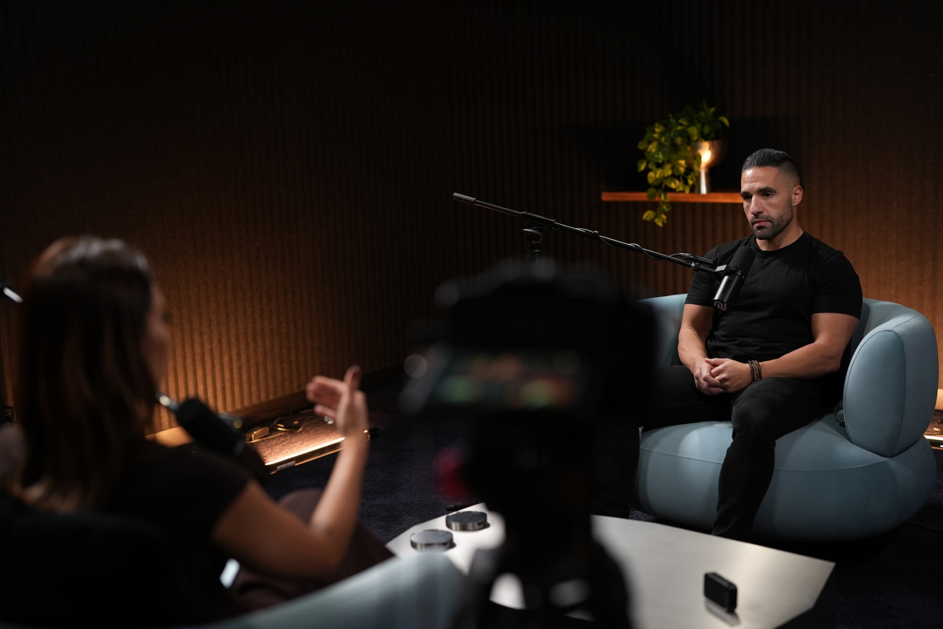 Moody dark set with timber slat wall and blue lounge chairs
